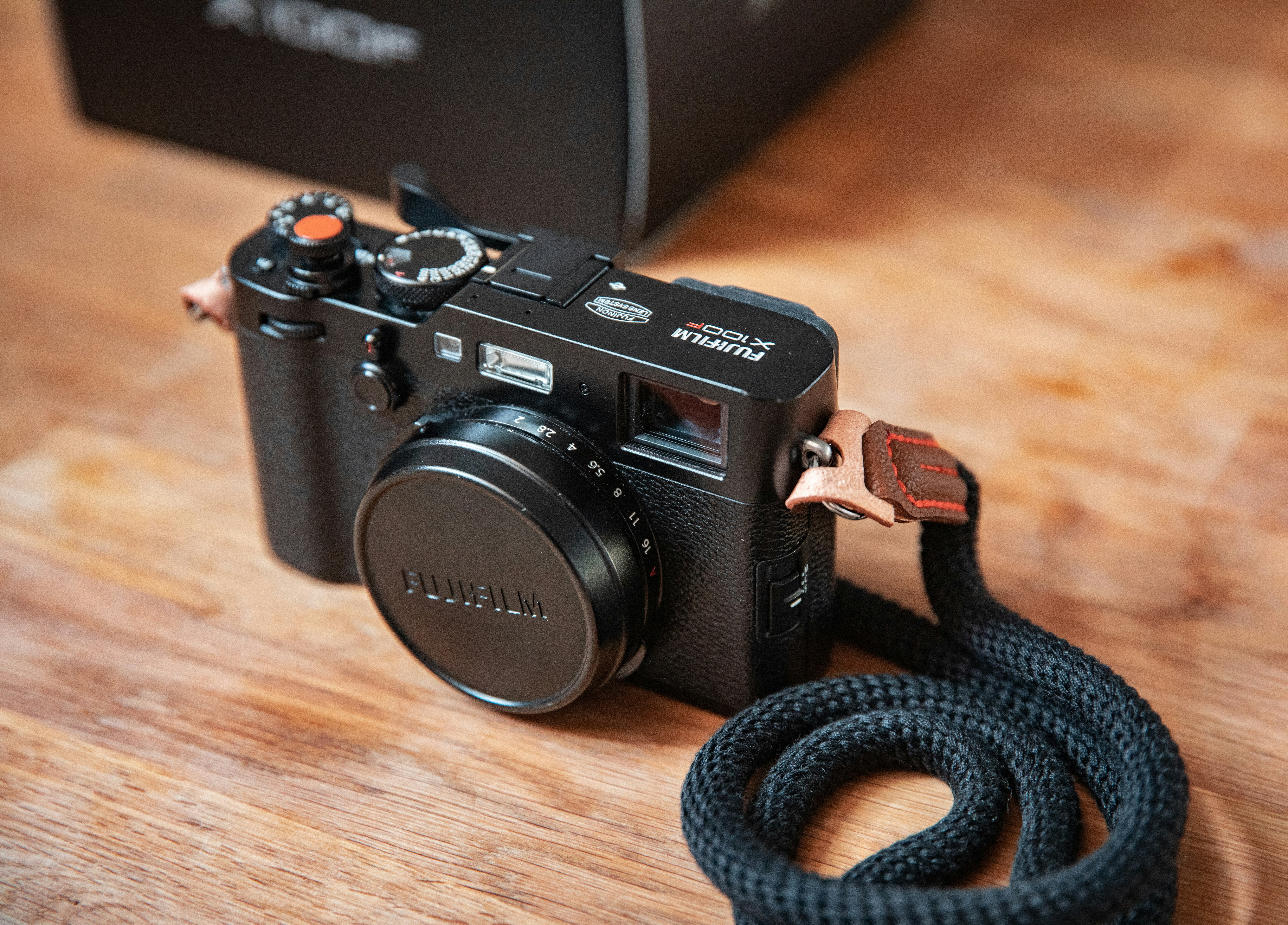 black nikon dslr camera on brown wooden table